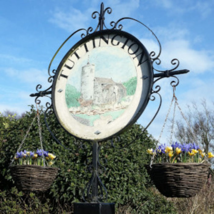 Village sign bedecked with bulbs